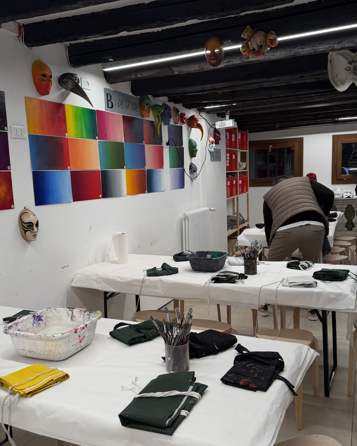 Inside the workshop, Dorsoduro — colour on the wall, work on the tables.