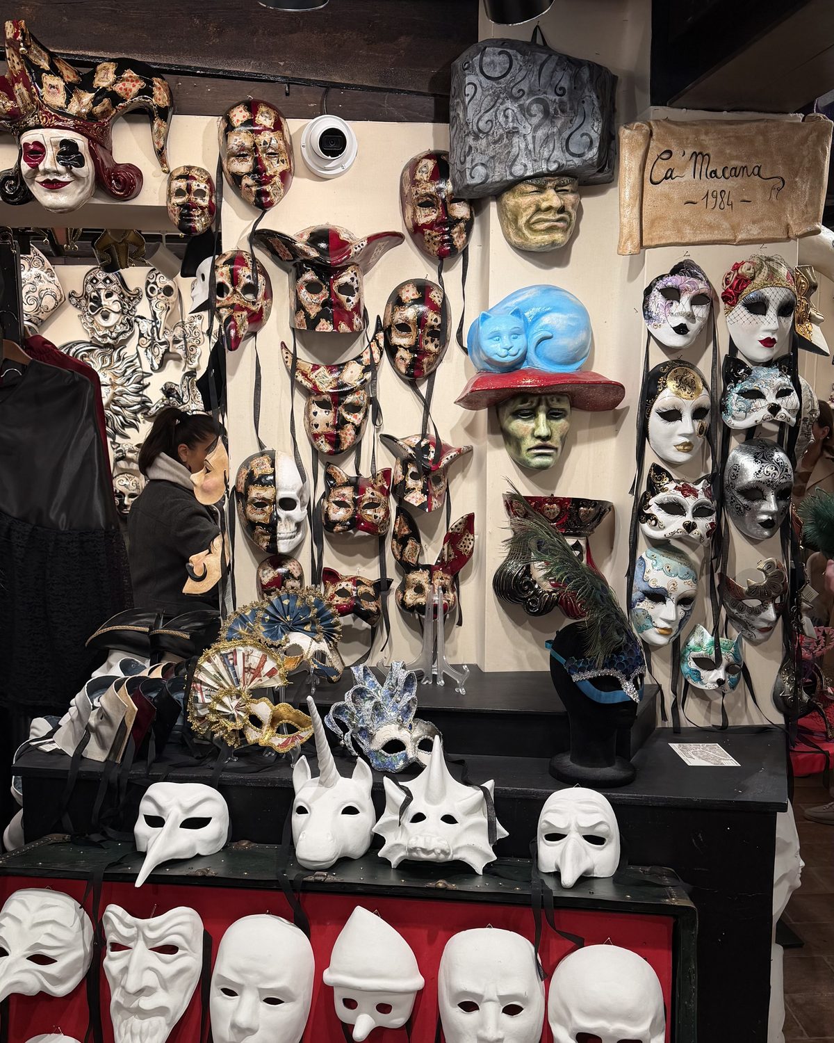 Bauta, plague doctor, jester — the old vocabulary, still on the wall.